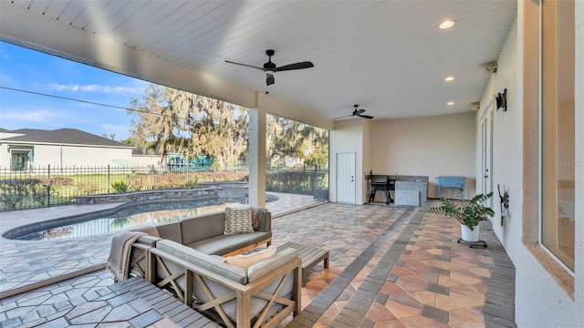 view of patio / terrace with area for grilling, a ceiling fan, and a fenced backyard