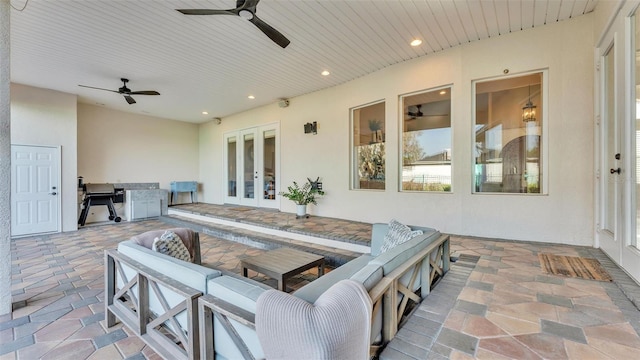 view of patio with area for grilling, french doors, and ceiling fan