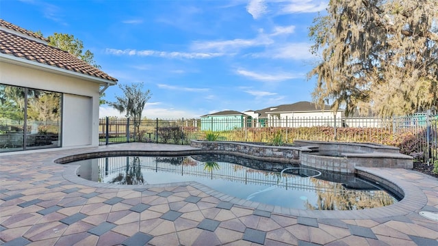 view of pool featuring a patio, a fenced backyard, a fenced in pool, and an in ground hot tub