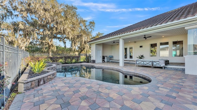 view of pool featuring a patio area, french doors, a fenced backyard, and ceiling fan