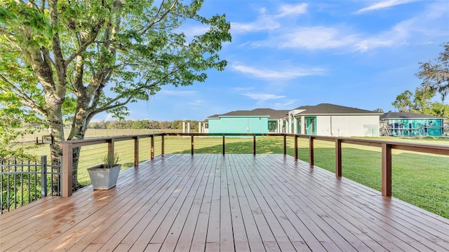 wooden terrace featuring a lawn