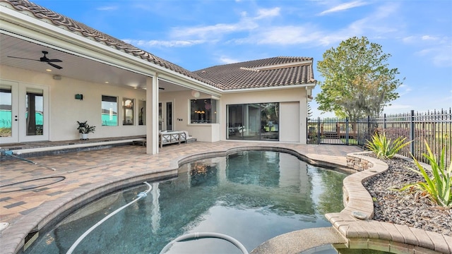 view of swimming pool featuring french doors, fence, a ceiling fan, and a patio