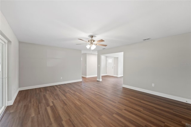 empty room with visible vents, baseboards, wood finished floors, and a ceiling fan