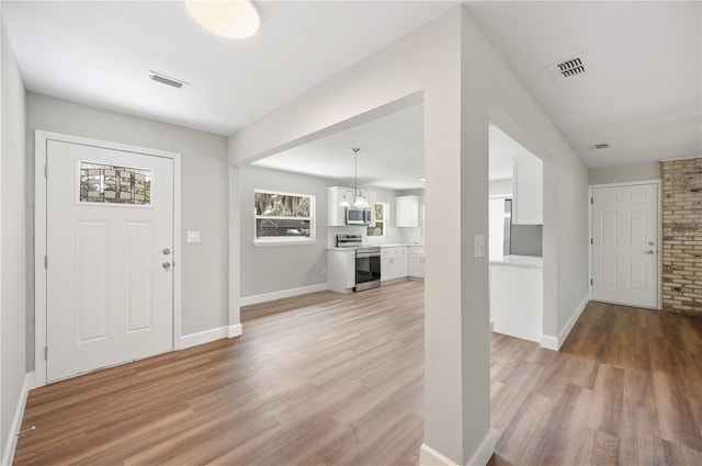 entryway featuring light wood-type flooring and visible vents