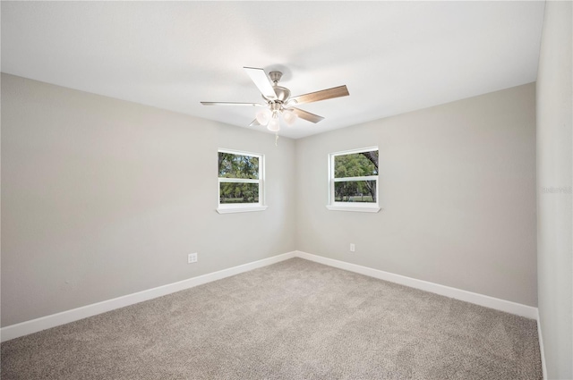 unfurnished room with carpet flooring, baseboards, and ceiling fan