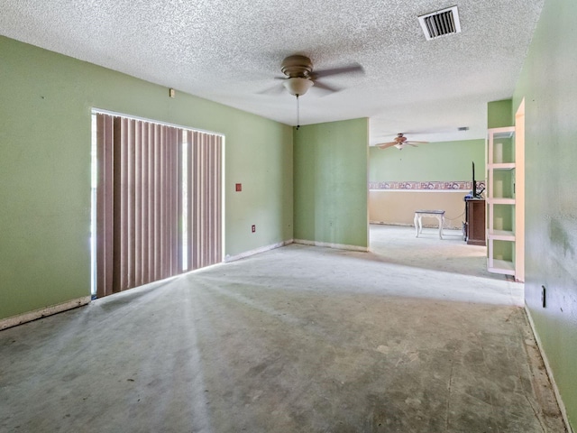 unfurnished room featuring a ceiling fan, visible vents, and a textured ceiling