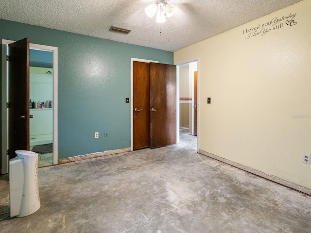 unfurnished bedroom with baseboards, visible vents, concrete floors, and a textured ceiling