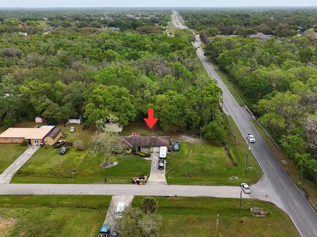 drone / aerial view with a wooded view