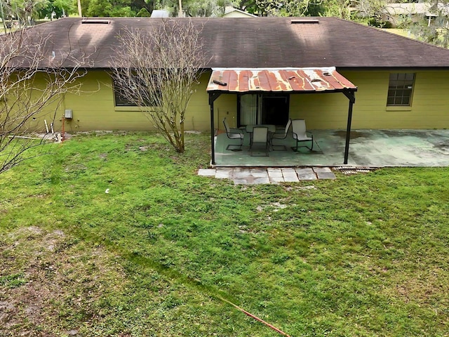 back of house featuring a patio and a yard