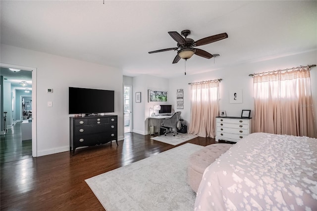 bedroom with a ceiling fan, dark wood-type flooring, and baseboards