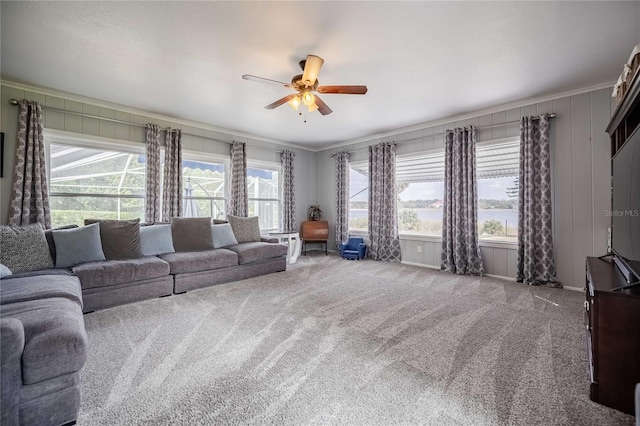 living room featuring carpet flooring, crown molding, and ceiling fan