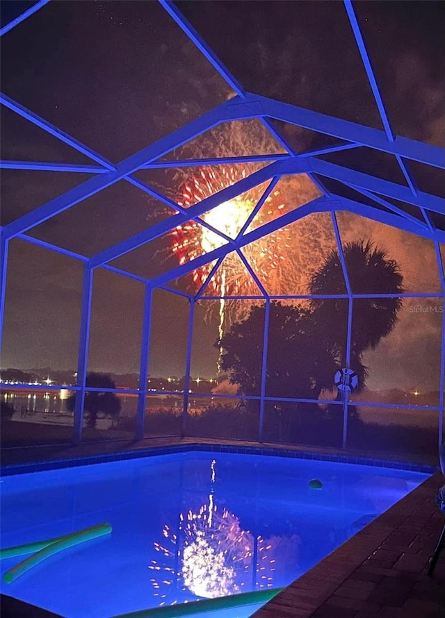 outdoor pool featuring glass enclosure