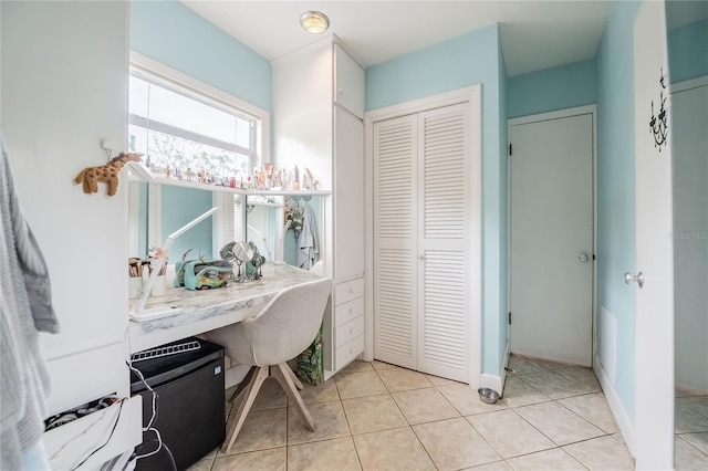 home office with light tile patterned floors and baseboards