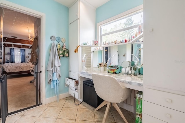 bathroom featuring tile patterned floors, baseboards, and ensuite bath