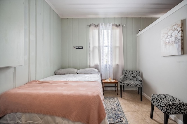 bedroom featuring light tile patterned floors and baseboards