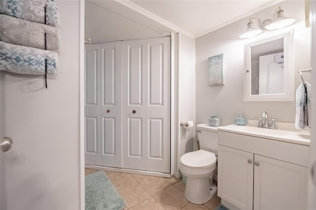 bathroom featuring tile patterned flooring, crown molding, toilet, and vanity