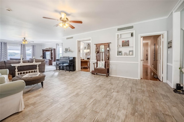 living area featuring light wood finished floors, visible vents, crown molding, and a ceiling fan