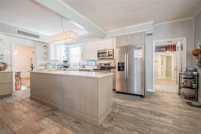 112 E Graham Park Dr, Haines City, FL 33844 - kitchen featuring appliances with stainless steel finishes, light wood-type flooring, ornamental molding, light stone countertops, and open shelves