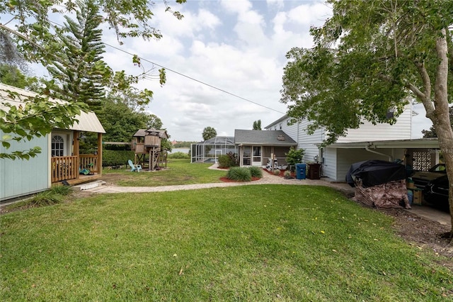 112 E Graham Park Dr, Haines City, FL 33844 - view of green lawn with a playground and glass enclosure