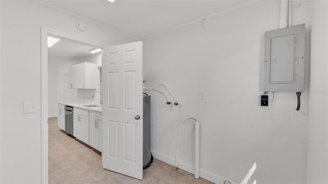 laundry room with electric panel, baseboards, and a sink