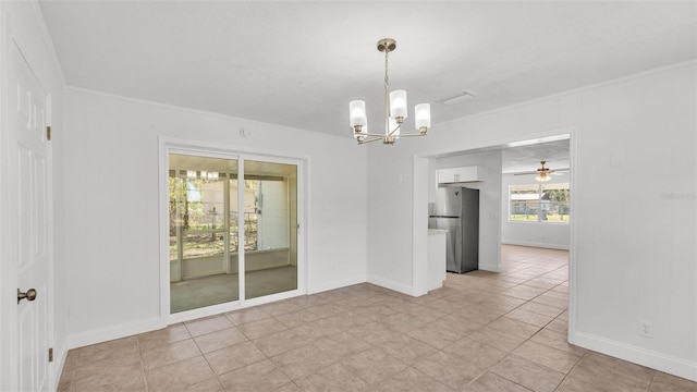 interior space with ceiling fan with notable chandelier, baseboards, visible vents, and ornamental molding