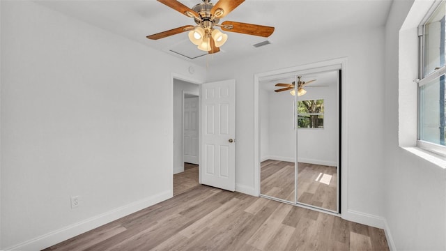 unfurnished bedroom featuring visible vents, a ceiling fan, a closet, light wood finished floors, and baseboards