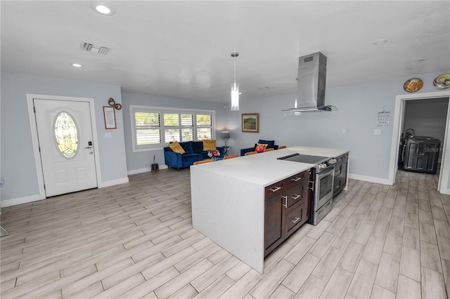 kitchen with stainless steel range with electric stovetop, light wood-style flooring, open floor plan, light countertops, and extractor fan