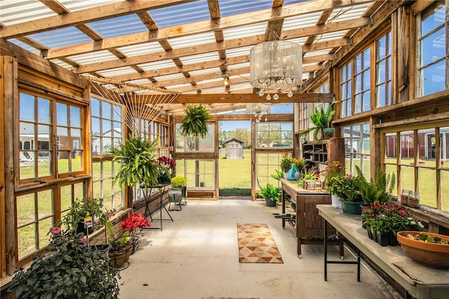 sunroom / solarium featuring a notable chandelier