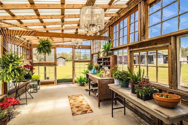 sunroom / solarium with an inviting chandelier