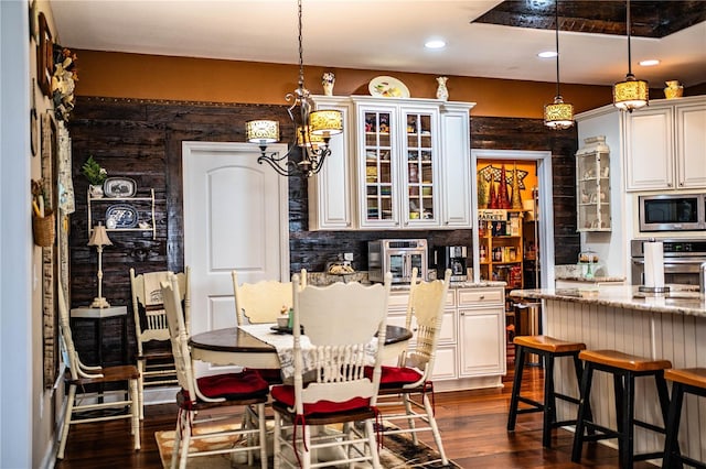 dining area featuring dark wood finished floors and recessed lighting