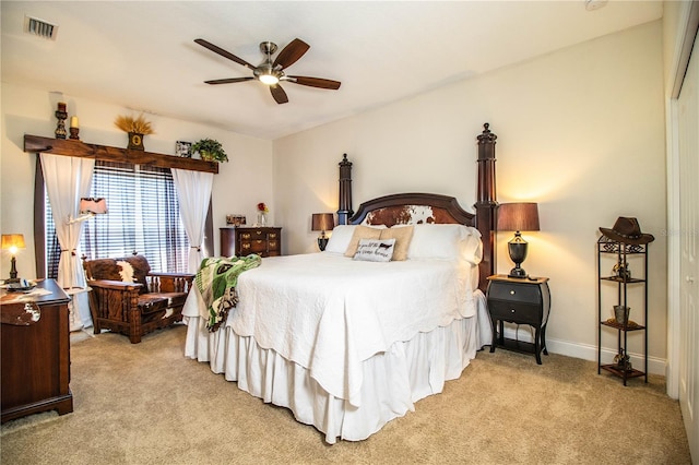 bedroom featuring ceiling fan, baseboards, visible vents, and light carpet