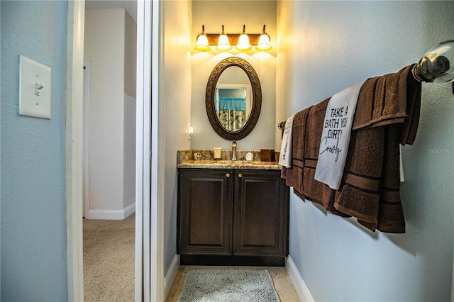 bathroom featuring baseboards and vanity