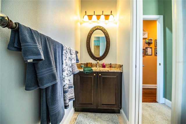 bathroom with vanity and baseboards