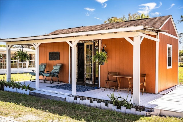 back of property with roof with shingles