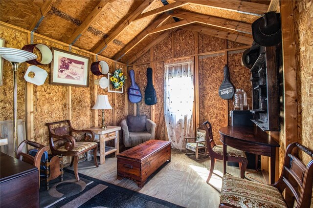 sitting room with lofted ceiling and wood finished floors