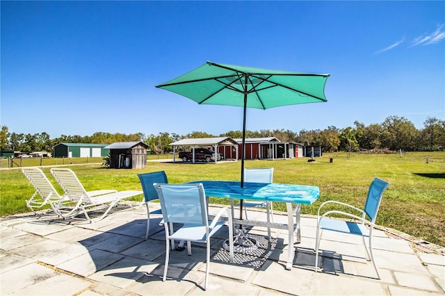 view of patio featuring an outbuilding and a storage unit