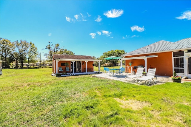 view of yard with an outbuilding and a patio