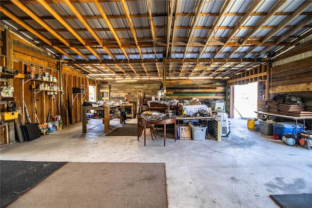 garage featuring a workshop area and metal wall