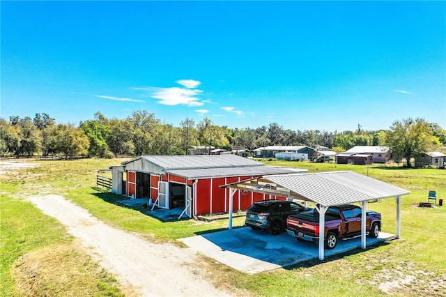 view of parking / parking lot featuring a carport and driveway