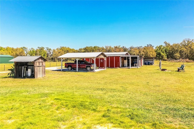 view of pole building with a carport and a lawn