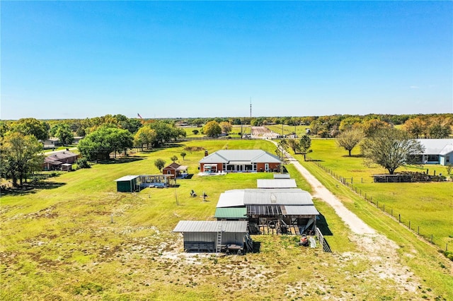 birds eye view of property with a rural view