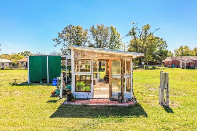 view of greenhouse featuring a yard