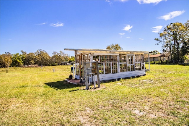 rear view of house featuring a lawn