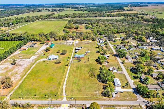 birds eye view of property with a rural view