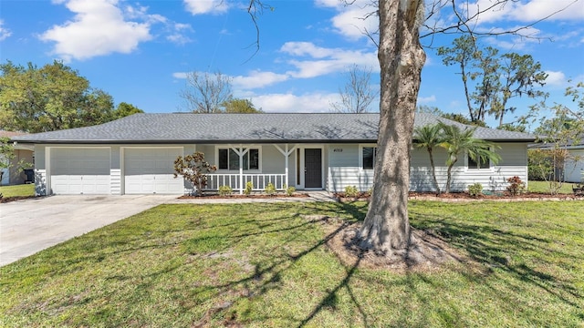 ranch-style home with a garage, covered porch, concrete driveway, and a front yard