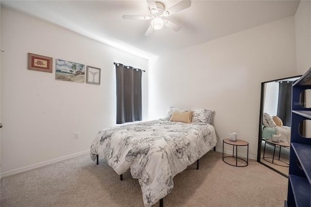 bedroom featuring baseboards, carpet floors, and a ceiling fan