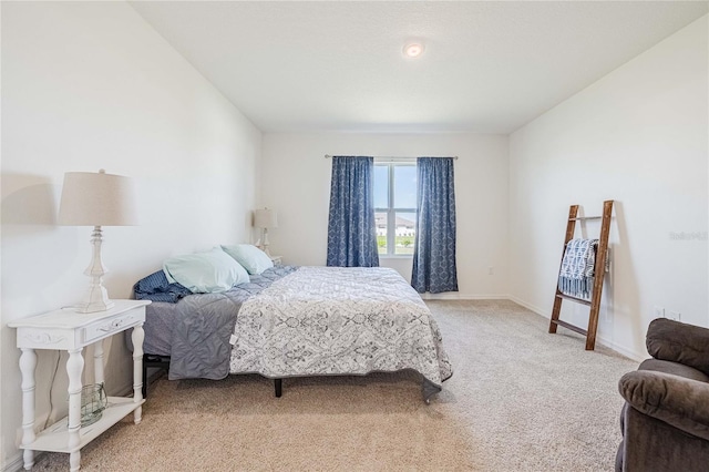 bedroom with light carpet and baseboards