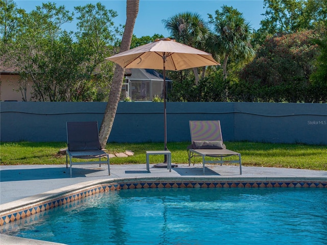 outdoor pool featuring a patio area and fence