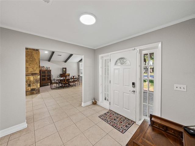 entrance foyer featuring light tile patterned flooring, baseboards, and ornamental molding