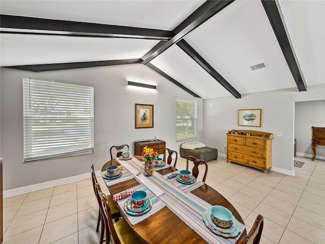 dining area featuring lofted ceiling with beams, light tile patterned floors, baseboards, and visible vents